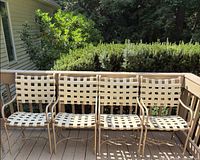 Four stationary armchairs on deck, showing overall design and finish