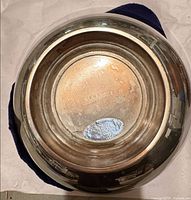 Underside of large round bowl showing maker stamp and wear