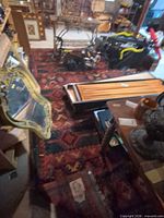 Full view of the wool area rug on floor with surrounding objects