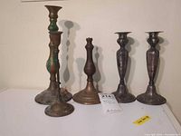 Five candlesticks side-by-side showing overall styles and condition