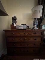 Front view of the 4-drawer brown wood dresser