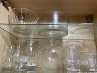 Overview of assorted glassware on cabinet shelf