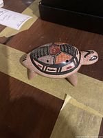 Ceramic turtle figurine with painted geometric design