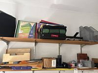 shelves with file folders, binders, magazine holders, binding punch, wood and plastic desk organizers