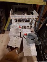 Overall lot showing bird cups in boxes and crate of metal camping cookware