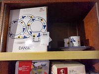 Box showing Dansk San Nicolo 20-piece stoneware set with pattern illustration