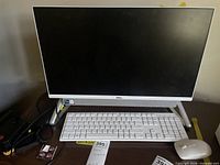 Front view of Dell all-in-one with keyboard and mouse