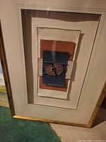 Front view of framed mixed media collage artwork
