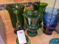Lineup of four larger glass vases/bowls in green and blue