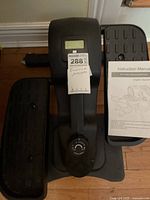 Top view of KYY mini elliptical showing LCD screen, both foot pedals and manual