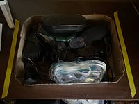 Box containing assorted sunglasses, cases and packaged goggles