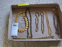 All seven necklaces laid in tray