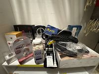 Overview of lot on white shelf showing CHI flat iron box, MSA 30X amplifier pack, bath salts jar, Light Relief bag, cables