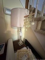 Full view of lamp showing acrylic base, capiz discs, fabric shade and size context