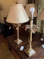 Both lamps with shades, showing palm-leaf tops and square bases