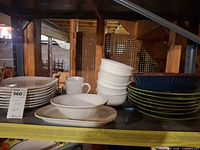 full view of assorted dinnerware on shelf