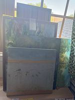 Group shot of five stacked canvases showing subjects and sizes