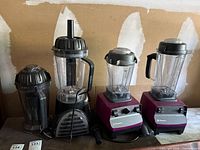 All blender bases, jars, lids and tamper on tabletop