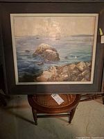 Front view of framed seascape painting showing image and frame condition
