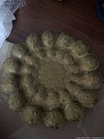 Gold-tone metal platter with raised floral relief