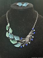 Necklace and earrings displayed on bust