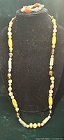 Full view of continuous strand necklace on bust