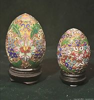 Front view of both cloisonné eggs on stands