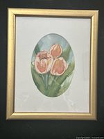 Front view of framed artwork showing oval tulip image, white mat and gold frame