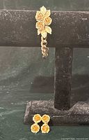 Bracelet on stand, earrings below