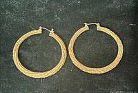 front view of both gold-tone textured hoop earrings