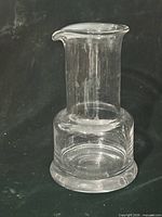 Front view of clear glass carafe showing shape and pour spout