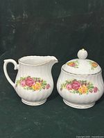 Creamer and lidded sugar bowl front view showing pattern and form
