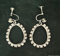 Front view of both teardrop rhinestone earrings showing overall design and condition