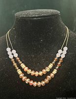 Full view of two-strand necklace on display bust