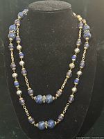Full view of two-strand beaded necklace on display bust