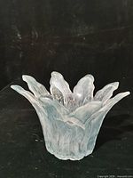Angled view showing ruffled teal glass bowl