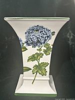 Front view showing blue chrysanthemum floral design and square base