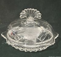 Lidded butter dish assembled showing etched floral design and fan finial