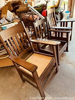 Three wooden armchairs side by side showing overall design