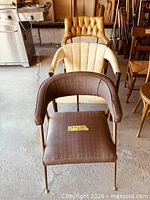 Three vintage upholstered chairs front view