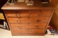 Front view showing all drawers closed, brass handles and overall condition