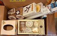 Overview of box showing tissue cover, body-care set, taper candles, horse graphic box and other packaged items