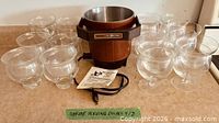 Front view of deep fryer and twelve glass dishes
