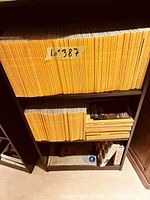 Two shelves filled with yellow-spined National Geographic magazines and additional magazines below