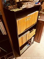 Front view of black bookcase with two shelves
