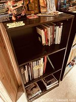 Front view of black bookcase showing shelves