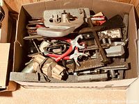 Overview of box filled with assorted vintage hand tools