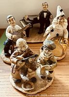 Group shot showing all four ceramic musician figurines