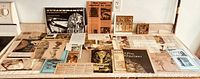 Wide view of entire lot: ring, plaque, assorted papers laid on countertop