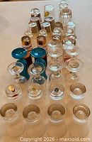 Front angled view showing assortment of shot glasses in rows
